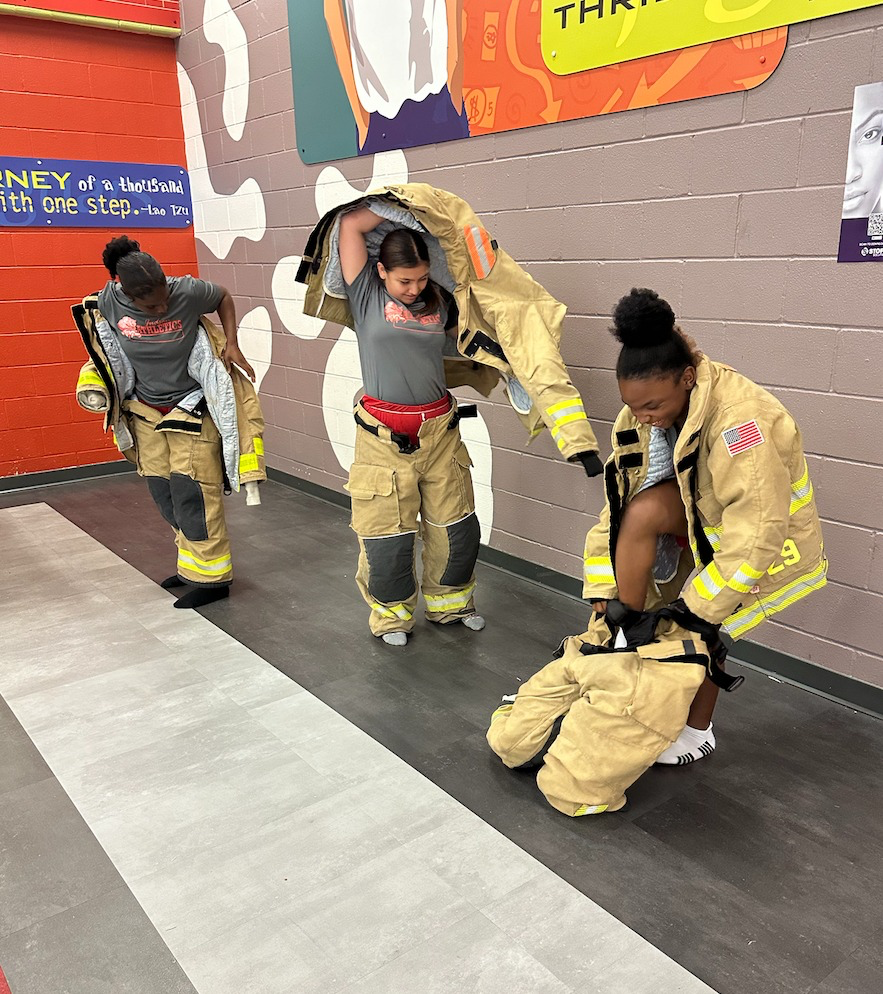 Judson MS putting on a firefighter suit