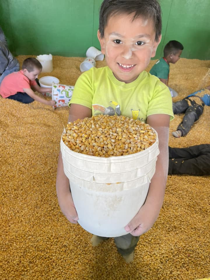 Dickinson students with a pile of corn kernels.