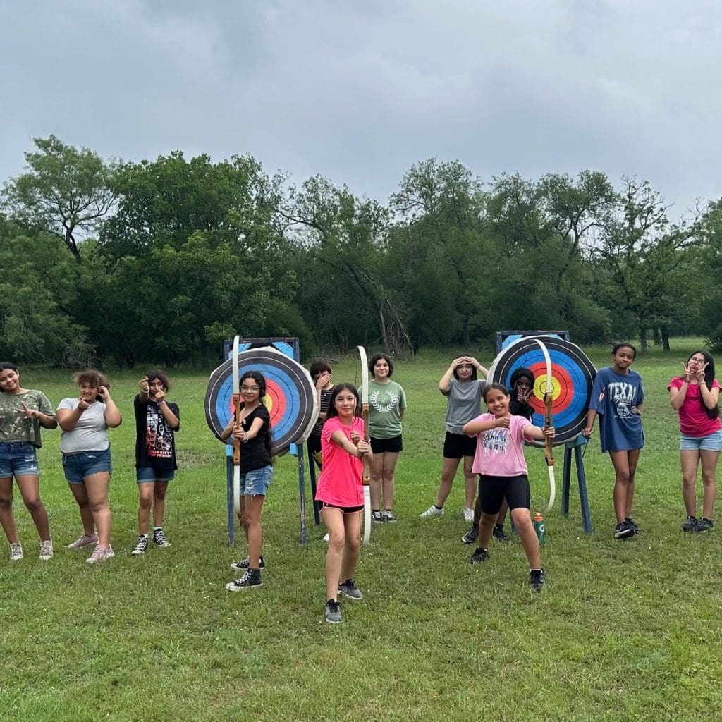 Southwest ISD students playing archery with the Gamma Sigma Pearls.