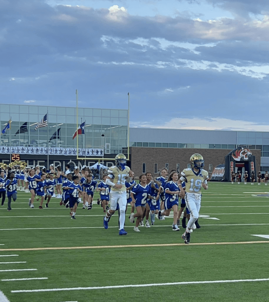 ems elementary school students running down football field