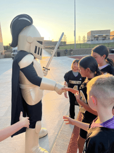 elementary students with high school mascot