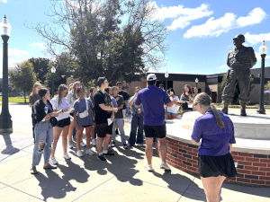 c.o.o.l. students gathering around tour guide