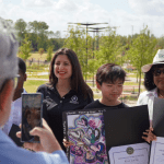 teacher with student showcasing art