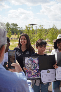 teacher with student showcasing art